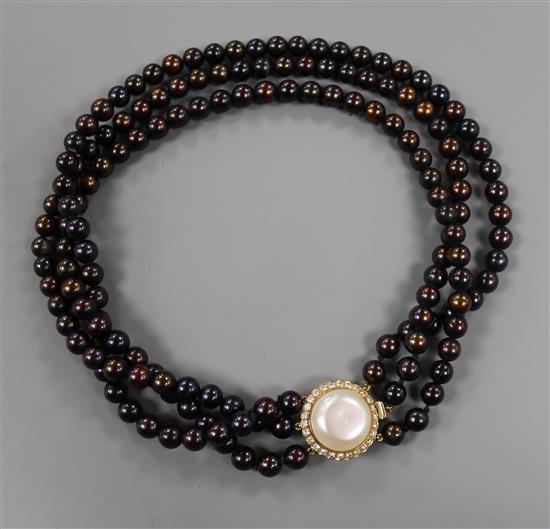 A triple strand cultured chocolate pearl choker necklace with 18ct gold, mabe pearl and diamond set clasp, approx. 36cm.